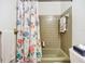 Bathroom featuring floral shower curtain, vintage green bathtub and coordinated towel racks at 2705 21St W Ave, Bradenton, FL 34205