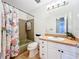 Bathroom featuring floral shower curtain, vintage green bathtub and coordinated countertop at 2705 21St W Ave, Bradenton, FL 34205