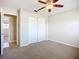 Carpeted bedroom with neutral paint, and a closet with sliding doors at 2705 21St W Ave, Bradenton, FL 34205
