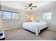 Comfortable bedroom with large windows and a ceiling fan at 2705 21St W Ave, Bradenton, FL 34205