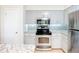 Renovated kitchen with granite counters, stainless appliances and stylish backsplash at 2705 21St W Ave, Bradenton, FL 34205