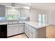 Updated kitchen with gray cabinets, granite countertops, and stainless steel appliances at 2705 21St W Ave, Bradenton, FL 34205