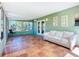 Light-filled sunroom with terracotta floors and views of the backyard at 2705 21St W Ave, Bradenton, FL 34205