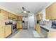 Well-lit kitchen features stainless steel appliances, granite countertops, and light wood cabinets at 3119 40Th W Ave, Bradenton, FL 34205