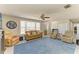 Bright living room boasts a big bay window, ceiling fan, and ample seating creating a cozy atmosphere at 3119 40Th W Ave, Bradenton, FL 34205
