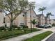 Charming townhome featuring an attached one-car garage and lovely, mature landscaping at 3938 Yellowstone Cir, Sarasota, FL 34233
