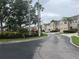 Scenic street view of this community with mature trees and landscaping at 3938 Yellowstone Cir, Sarasota, FL 34233