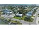 High angle of a coastal home surrounded by mature palms and lush greenery close to the water at 412 73Rd St, Holmes Beach, FL 34217