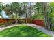 Spacious backyard with lush lawn, mature landscaping, and fencing at 412 73Rd St, Holmes Beach, FL 34217