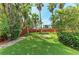 Backyard features a lawn, privacy fence, lush landscaping, and a fire pit area at 412 73Rd St, Holmes Beach, FL 34217