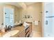 Bathroom with double sink vanity, decorative mirrors, and walk-in shower at 412 73Rd St, Holmes Beach, FL 34217