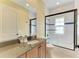 Well-appointed bathroom featuring a granite-topped vanity and shower-tub combination with stylish glass doors at 412 73Rd St, Holmes Beach, FL 34217