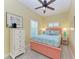 Charming bedroom with yellow walls, a patterned bed, and bright white trim, reflecting a coastal vibe at 412 73Rd St, Holmes Beach, FL 34217