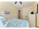 Inviting bedroom with soft yellow walls featuring a bed, a dresser, and closet doors at 412 73Rd St, Holmes Beach, FL 34217