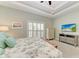 Bright bedroom is complete with tray ceilings, carpet, and comfortable bed at 412 73Rd St, Holmes Beach, FL 34217