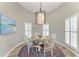 Bright dining room with a glass table, comfortable seating, and sunlit shutters at 412 73Rd St, Holmes Beach, FL 34217