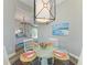 Cozy dining room features a modern glass table and artwork that complements the decor at 412 73Rd St, Holmes Beach, FL 34217