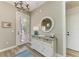 Bright entryway features a decorative mirror, a console table, and an elegant chandelier at 412 73Rd St, Holmes Beach, FL 34217