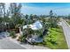 Beautiful home surrounded by lush landscaping, mature trees, and large green yard at 412 73Rd St, Holmes Beach, FL 34217