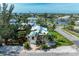 Charming home featuring lush landscaping, a brick driveway, and a water view at 412 73Rd St, Holmes Beach, FL 34217