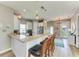 Spacious kitchen bar with granite countertops, pendant lights and a view of the entryway at 412 73Rd St, Holmes Beach, FL 34217