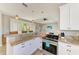 Bright kitchen features granite countertops, stainless steel appliances, and pendant lighting at 412 73Rd St, Holmes Beach, FL 34217