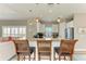 Inviting kitchen bar featuring granite countertops, pendant lighting, and bar stool seating at 412 73Rd St, Holmes Beach, FL 34217