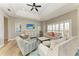 Bright living room features tray ceilings, fan, wood flooring and comfortable seating at 412 73Rd St, Holmes Beach, FL 34217