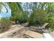 Expansive brick patio with table, chairs, lounge seating, a grill and mature landscaping at 412 73Rd St, Holmes Beach, FL 34217