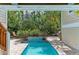 Lush tropical foliage surrounds a serene, private pool at 412 73Rd St, Holmes Beach, FL 34217