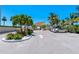 Community entrance with lush landscaping, palm trees and covered entry at 4350 Chatham Dr # E-105, Longboat Key, FL 34228