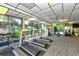 Well-equipped gym featuring treadmills, weights, and large windows with natural light at 4350 Chatham Dr # E-105, Longboat Key, FL 34228