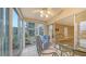 Cozy lanai with seating area, glass table, and sliding doors providing a peaceful view at 4350 Chatham Dr # E-105, Longboat Key, FL 34228