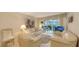 Comfortable living room featuring plush sofas, neutral decor, and bright natural light at 4350 Chatham Dr # E-105, Longboat Key, FL 34228
