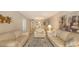 Bright living room featuring plush sofas, decorative artwork, and open dining area at 4350 Chatham Dr # E-105, Longboat Key, FL 34228