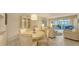 Inviting living room and dining area with tile floors, elegant furnishings, and sliding glass doors to lanai at 4350 Chatham Dr # E-105, Longboat Key, FL 34228