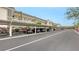 Convenient covered parking area outside the condos with mature palms and vibrant flowers at 4350 Chatham Dr # E-105, Longboat Key, FL 34228