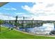 Beautiful water view from condo with boats docked along the canal and green grassy areas at 4350 Chatham Dr # E-105, Longboat Key, FL 34228