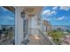 Balcony featuring ornate railings, a small table, and views of the water and neighboring buildings at 464 Golden Gate Pt # 702, Sarasota, FL 34236