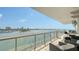 Spacious waterfront balcony perfect for entertaining, featuring comfortable seating and city views at 464 Golden Gate Pt # 702, Sarasota, FL 34236