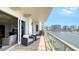 Spacious balcony featuring comfortable seating and expansive water and cityscape views at 464 Golden Gate Pt # 702, Sarasota, FL 34236