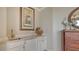 Elegant bar area with marble countertop, stylish decor, and attractive wood cabinet at 464 Golden Gate Pt # 702, Sarasota, FL 34236