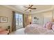 Bedroom with balcony, natural light, ceiling fan and comfortable furniture at 464 Golden Gate Pt # 702, Sarasota, FL 34236