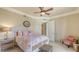Cozy bedroom with natural light, stylish furnishings, and ceiling fan at 464 Golden Gate Pt # 702, Sarasota, FL 34236