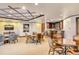 Inviting common area with multiple seating options, a wet bar and TV at 464 Golden Gate Pt # 702, Sarasota, FL 34236