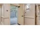 Garage entrance from hallway displaying finished walls and ceiling, door hardware and overhead lighting at 464 Golden Gate Pt # 702, Sarasota, FL 34236