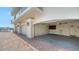 View into a spacious garage showing storage, painted walls and ceiling, and an access door at 464 Golden Gate Pt # 702, Sarasota, FL 34236