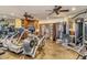 Home gym with state-of-the-art equipment, mirrored walls, and ceiling fans at 464 Golden Gate Pt # 702, Sarasota, FL 34236