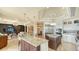 Open concept kitchen with two islands, stainless steel appliances, and stylish pendant lighting at 464 Golden Gate Pt # 702, Sarasota, FL 34236