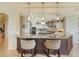 A modern kitchen features a large island, granite counters, and stainless steel appliances at 464 Golden Gate Pt # 702, Sarasota, FL 34236